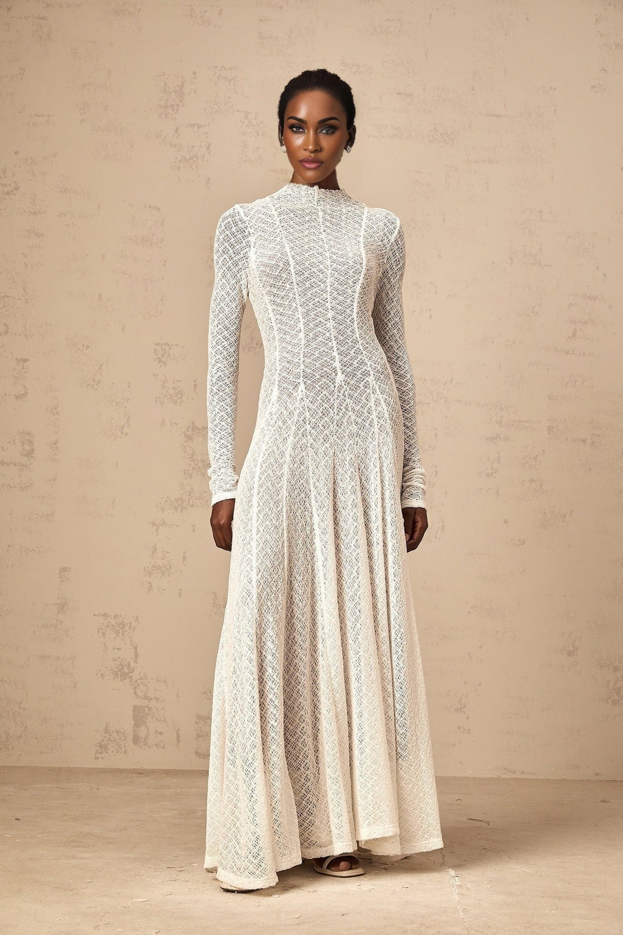 A long white lace maxi dress with a wavy pattern design named Athena
