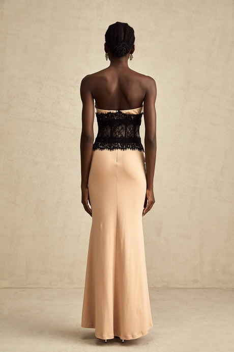 A long white lace maxi dress with an offshoulder neckline and corset bodice featuring delicate lace panels
