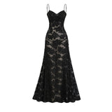 A long white lace maxi dress with floral patterns covering the entire garment featuring a high neckline and long sleeves