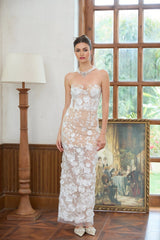 A long white maxi dress with a corset bodice featuring floral applique details named Brigitte