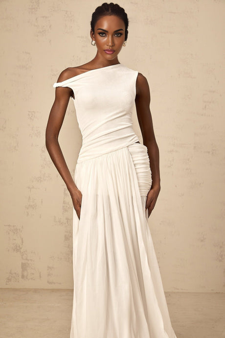 A long white maxi dress with a single shoulder strap and shirred panel detail