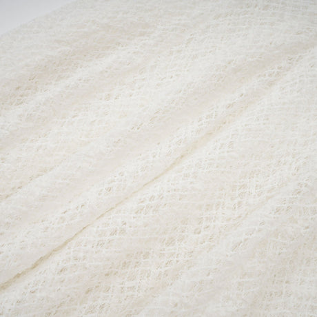 A long white maxi dress with a wavy lace pattern covering the entire garment featuring a feminine and elegant design