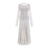 A long white maxi dress with a wavy lace pattern featuring a fitted bodice and flowing skirt