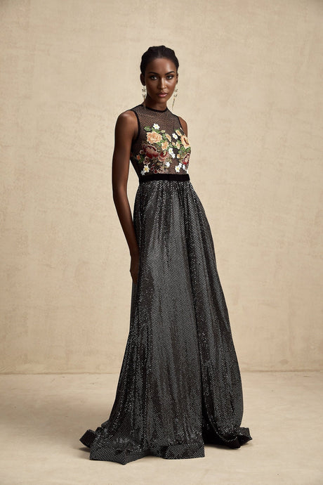 A long white maxi dress with colorful floral embroidery and embellishments covering the fabric