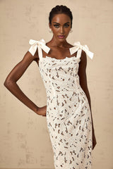 A long white maxi dress with colorful floral embroidery details named Eloise