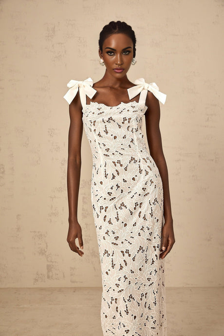 A long white maxi dress with floral embroidery details named Eloise