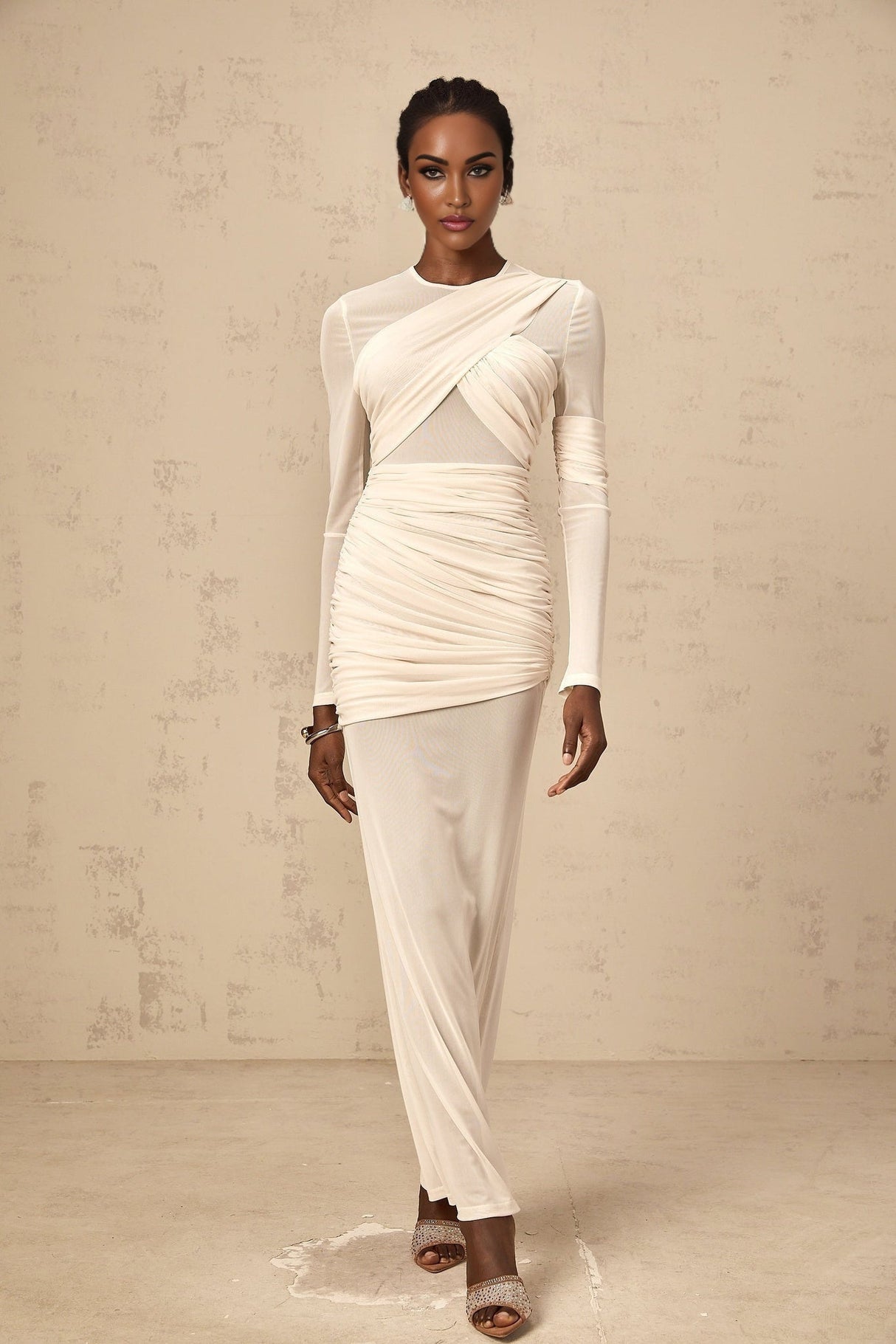 A long white maxi dress with ruched tulle detailing and a flowing silhouette named Veronique