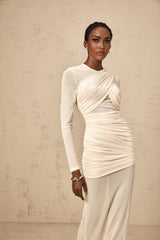 A long white maxi dress with ruched tulle details and a flowy silhouette