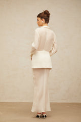 A long white maxi dress with sheer panels and a flowy silhouette