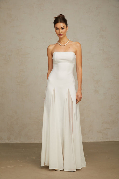 A long white maxi dress with tulle panelling details named Nathalie featuring a flowy silhouette and delicate sheer accents