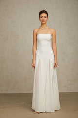 A long white maxi dress with tulle panelling featuring a sleeveless design and flowing skirt