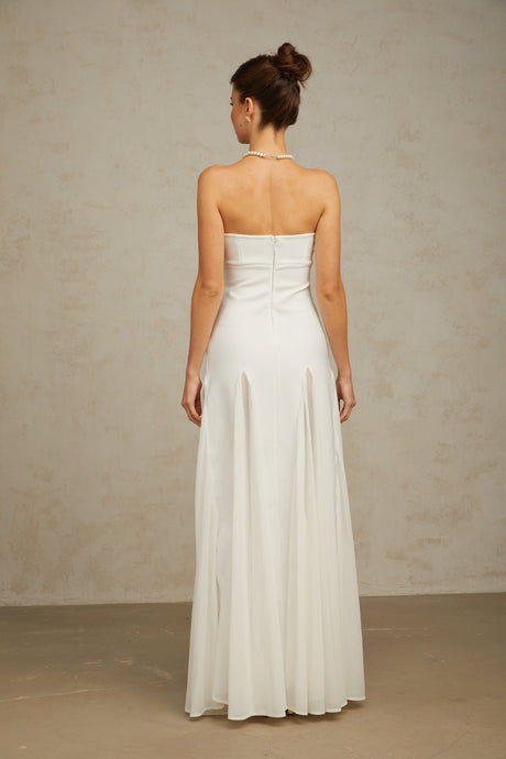 A long white maxi dress with tulle panels named Nathalie featuring a flowy silhouette and delicate feminine design