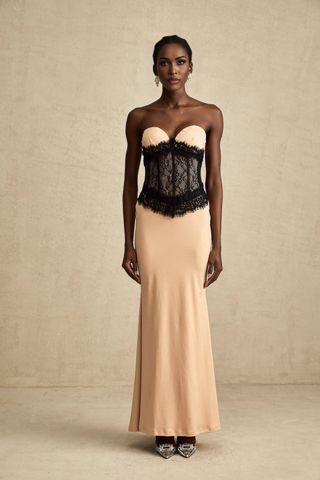 A long white offshoulder dress with lace panels and a corsetstyle bodice featuring a fitted waist and flowing maxi skirt