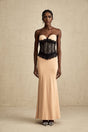 A long white offshoulder dress with lace panels and a corsetstyle bodice featuring a fitted waist and flowing maxi skirt