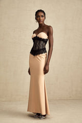 A long white offshoulder maxi dress with a corset bodice featuring delicate lace panels and a flowing skirt