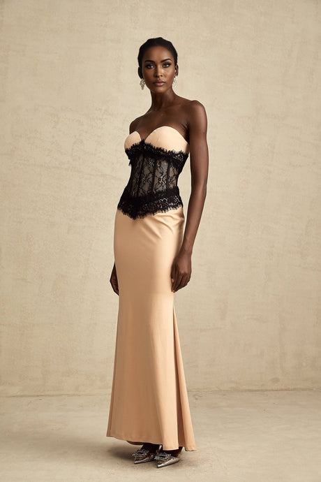 A long white offshoulder maxi dress with a corset bodice featuring delicate lace panels and a flowing skirt