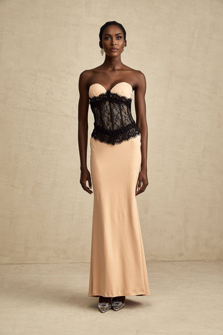 A long white offshoulder maxi dress with a fitted corset bodice featuring delicate lace panels and a flowing skirt