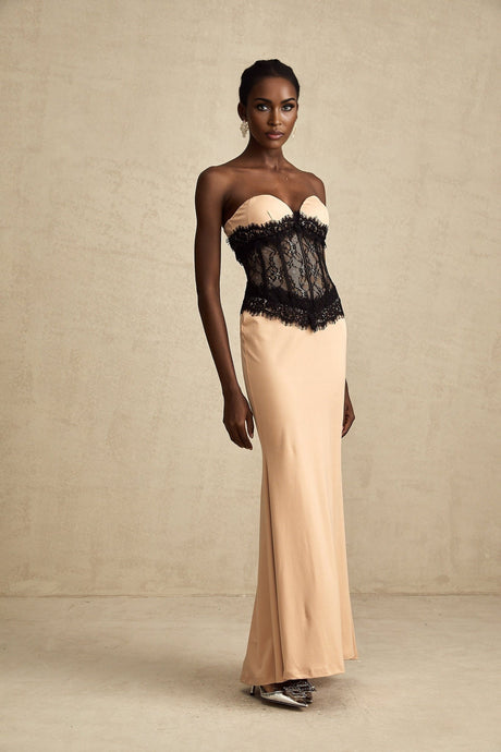 A long white offshoulder maxi dress with lace panels and a corsetstyle bodice featuring a fitted waist and flowing skirt