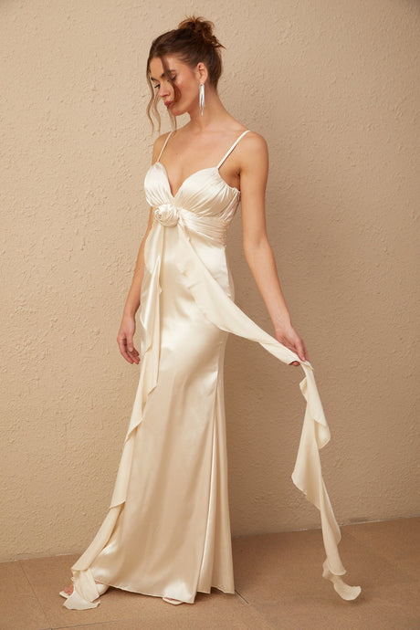A long white satin maxi dress with a corset bodice featuring colorful floral applique details