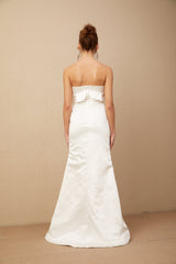 A long white satin maxi dress with floral applique details featuring a design inspired by Anna