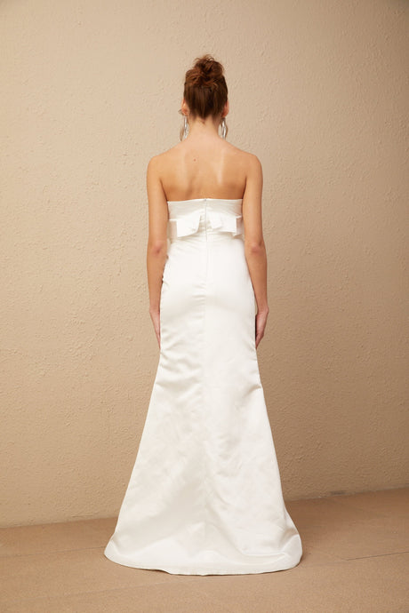 A long white satin maxi dress with floral applique details featuring a design inspired by Anna