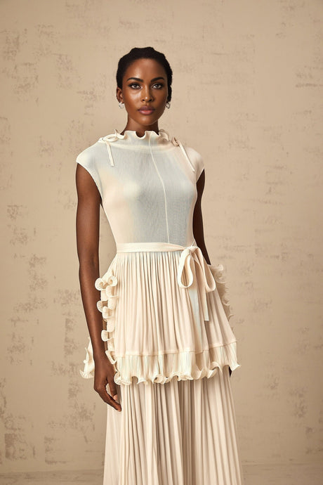 A long white sleeveless maxi dress with ruffles and pleats named Diana