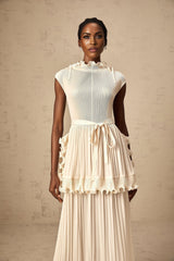 A long white sleeveless maxi dress with ruffles and pleats named Diana