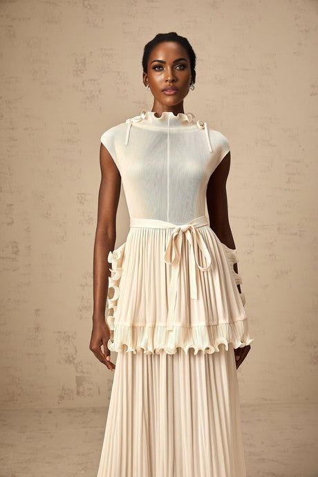 A long white sleeveless maxi dress with ruffles and pleats named Diana