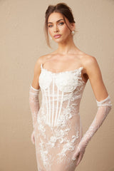 A long white tulle maxi dress with a corset bodice featuring colorful floral embroidery and delicate straps