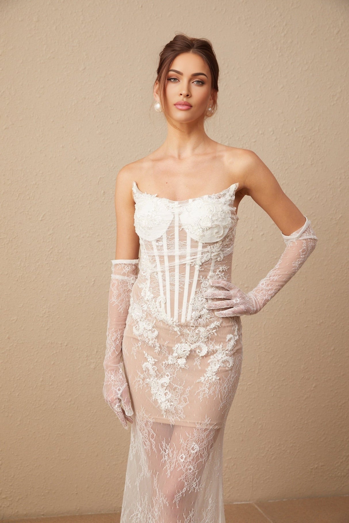 A long white tulle maxi dress with a corset bodice featuring colorful floral embroidery and thin straps