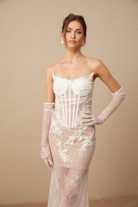 A long white tulle maxi dress with a corset bodice featuring colorful floral embroidery and thin straps