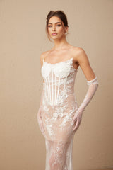 A long white tulle maxi dress with a corset bodice featuring colorful floral embroidery and thin straps