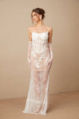 A long white tulle maxi dress with a corset bodice featuring delicate floral embroidery throughout The dress has a fitted waist and a flowing skirt