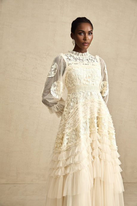 A long white tulle maxi dress with layered skirt featuring delicate floral embroidery in pastel colors named Capucine