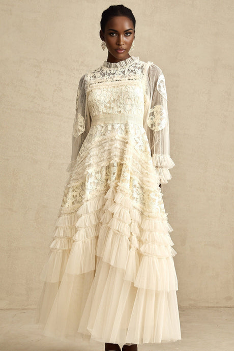 A long white tulle maxi dress with multiple layers featuring delicate floral embroidery in vibrant colors covering the bodice and scattered throughout the skirt
