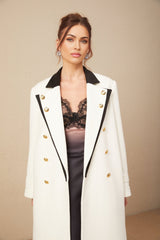 A long wool blazer featuring color blocking and a doublebreasted design in shades of terracotta and beige