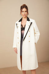 A long wool blazer with color blocking featuring a doublebreasted front in terebinth green and contrasting colors