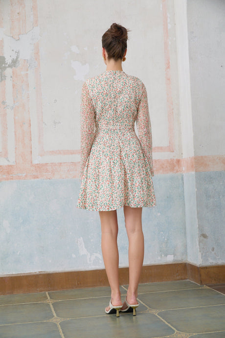 A Marion mini dress with a floral print pattern and pleated design on a white background