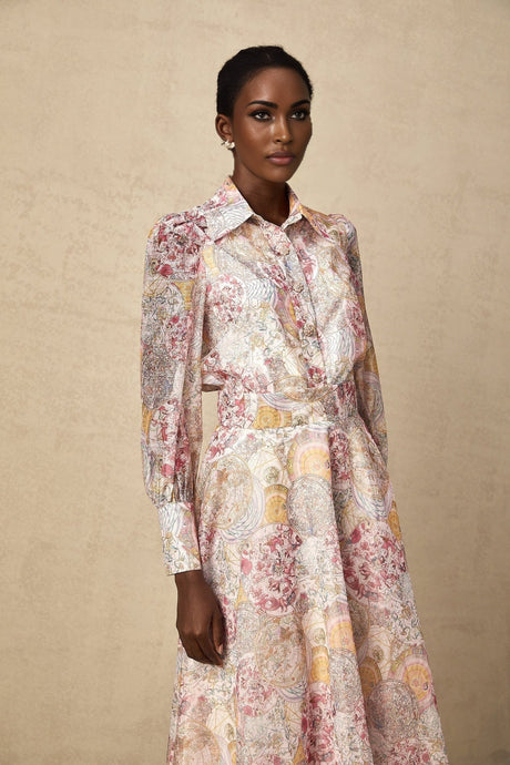 A matching set consisting of a cherry pink shirt and skirt both featuring a pattern print design