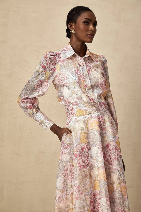 A matching set consisting of a cherry pink shirt and skirt with a pattern print design