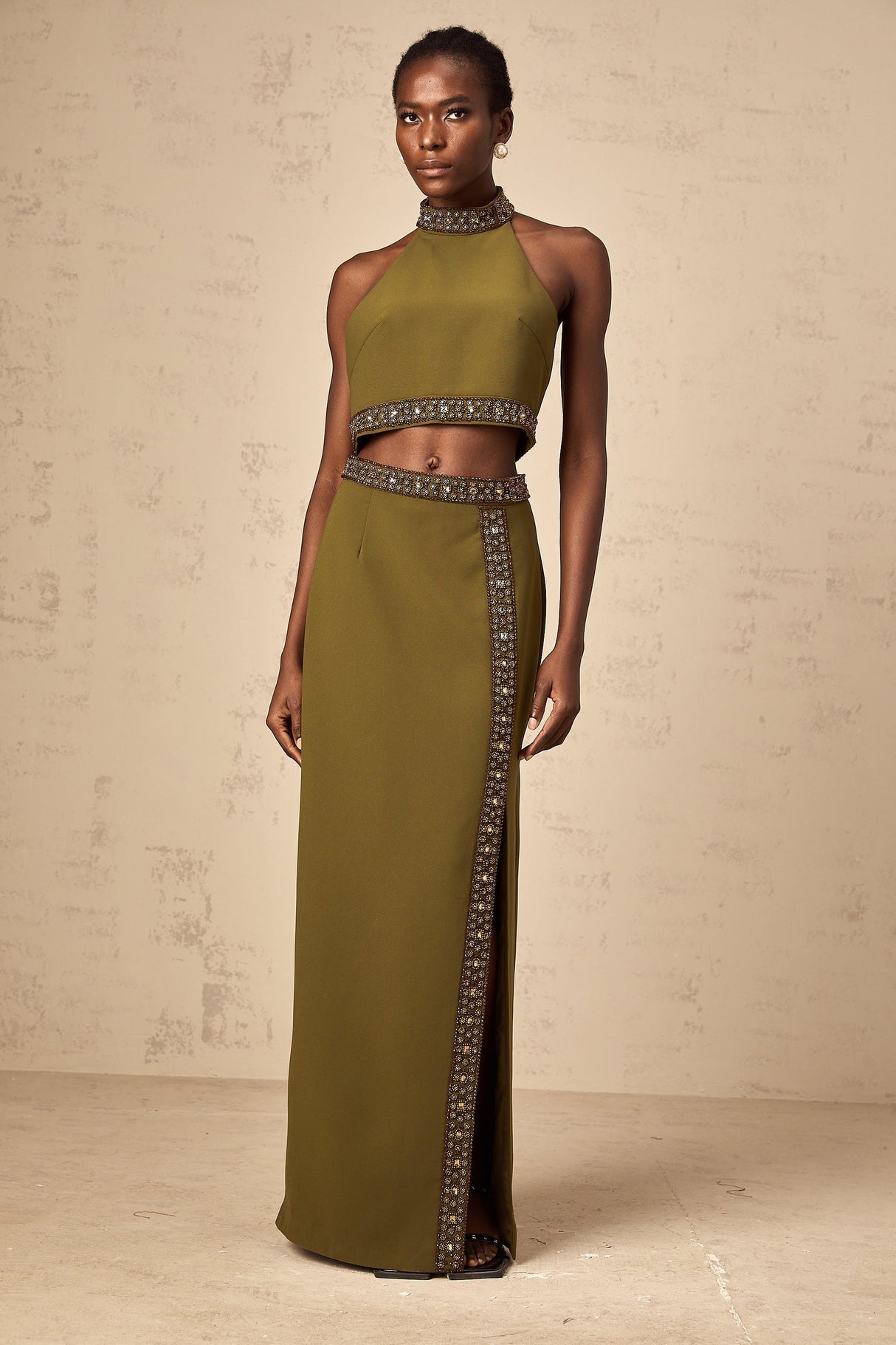 A matching set consisting of a green top and skirt with daisy beaded trim details The top and skirt have a light green color and feature decorative daisyshaped beads along the edges