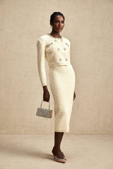 A matching set consisting of a knit cardigan and skirt both embellished with decorative details named Justine The cardigan and skirt are coordinated in style and color creating a cohesive outfit