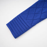 A matching set featuring a blue knitted top and skirt The top has button details Both pieces are made from a textured knit fabric The outfit is styled as a coordinated ensemble