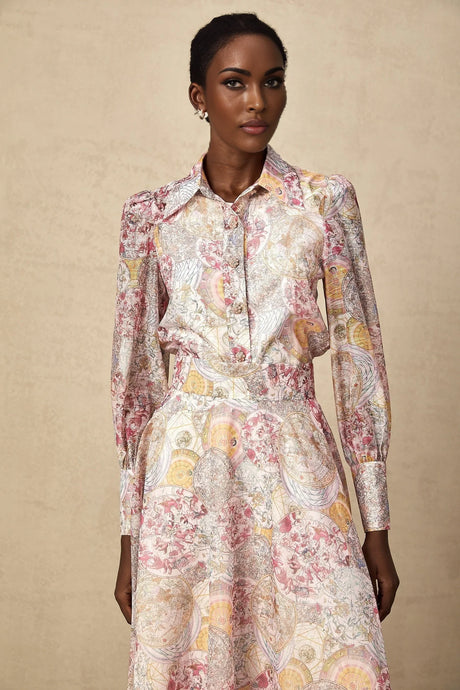 A matching set featuring a cherry pink shirt and skirt with a pattern print design both pieces coordinate in color and style