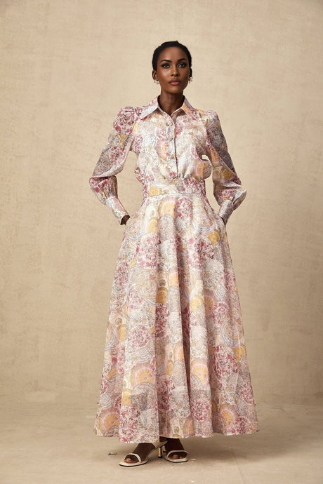 A matching set featuring a cherry pink shirt and skirt with a pattern print design The shirt and skirt are shown together as a coordinated outfit