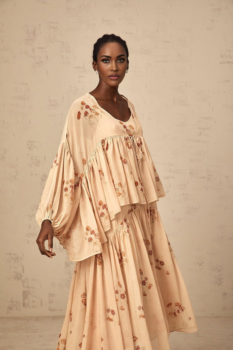 A matching set featuring a coralpink blouse and dress with floral print and pleated design