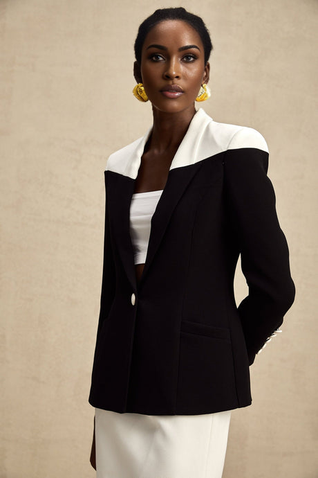 A matching set featuring a jacket and skirt in contrasting colors by Honorine