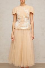 A matching set featuring a tulle top and skirt with floral applique details named Ludivine The ensemble has a delicate and feminine appearance with a sheer overlay adorned with floral embellishments