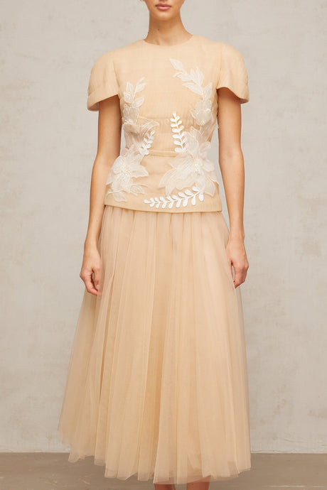 A matching set featuring a tulle top and skirt with floral applique details named Ludivine The ensemble has a delicate and feminine appearance with a sheer overlay adorned with floral embellishments