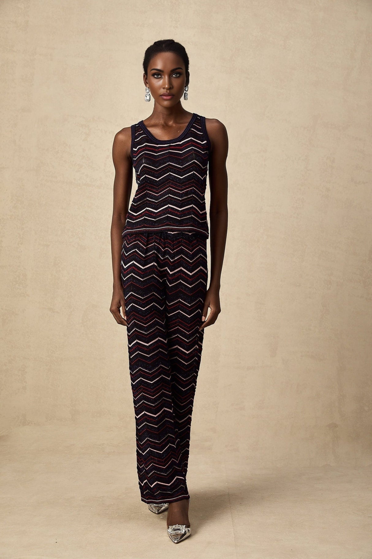 A matching set featuring a zigzag woven crochet knit top and trousers named Emmanuelle The set has a bohemian style with intricate texture and pattern